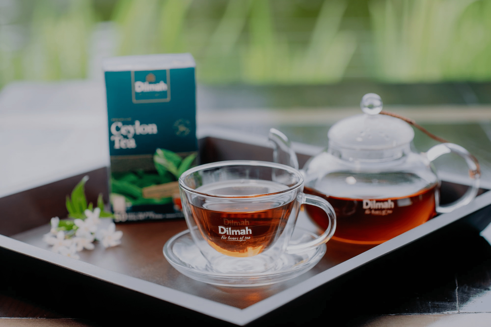 Tea set with Dilmah Ceylon Tea packaging, cup, and teapot on a tray, used as a visual in the case study on Russia-Promo