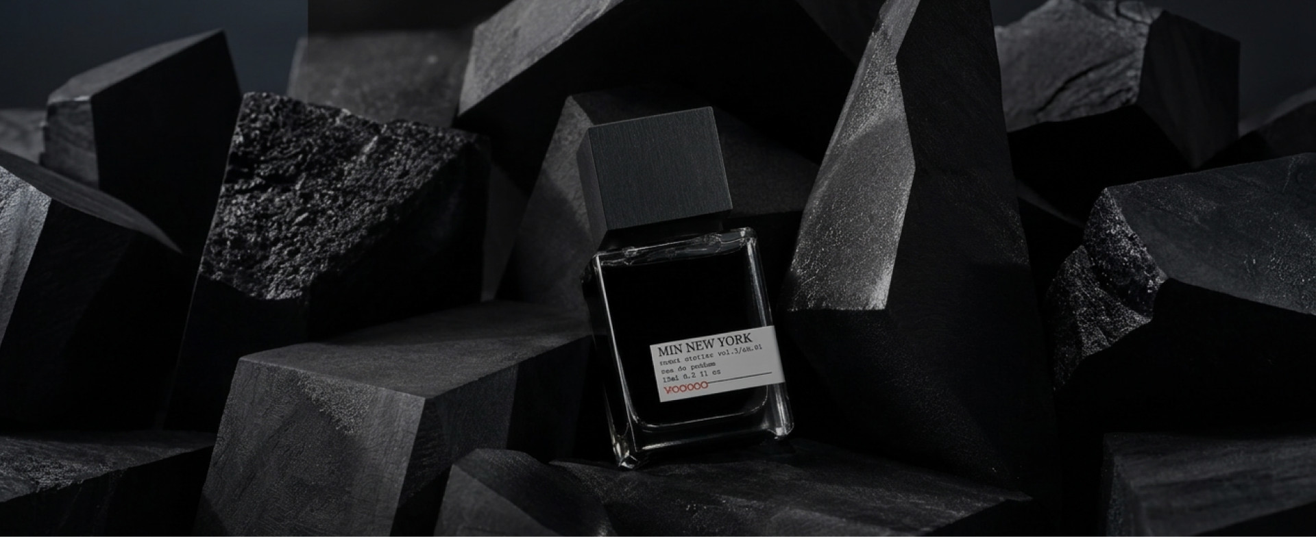 Minimalist MiN NEW YORK perfume bottle among black geometric shapes